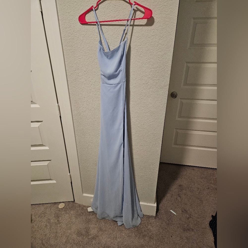 A long light blue dress with slit and laced up back